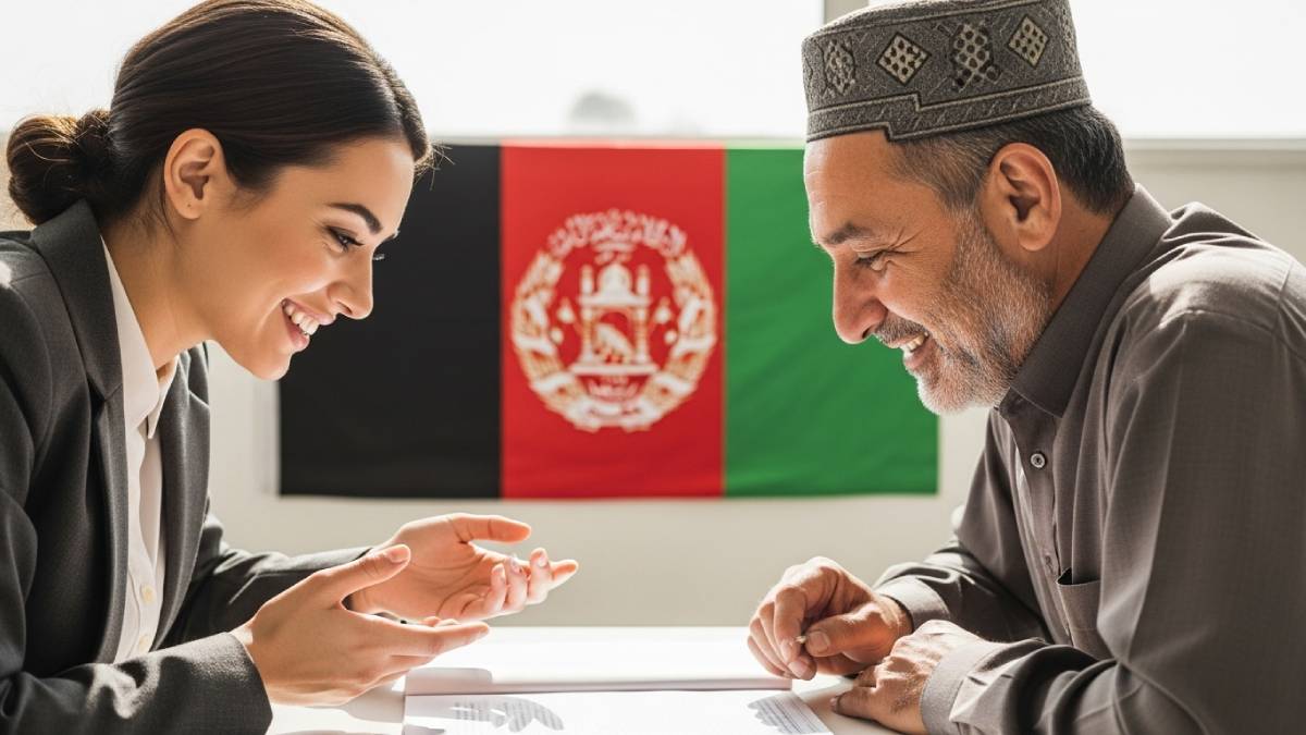 Traducteur avec client pachtophone, bureau moderne, drapeau afghan bien visible